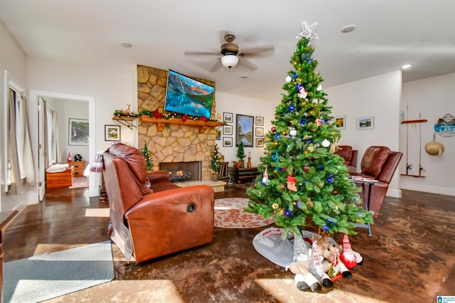 living room featuring ceiling fan and a fireplace