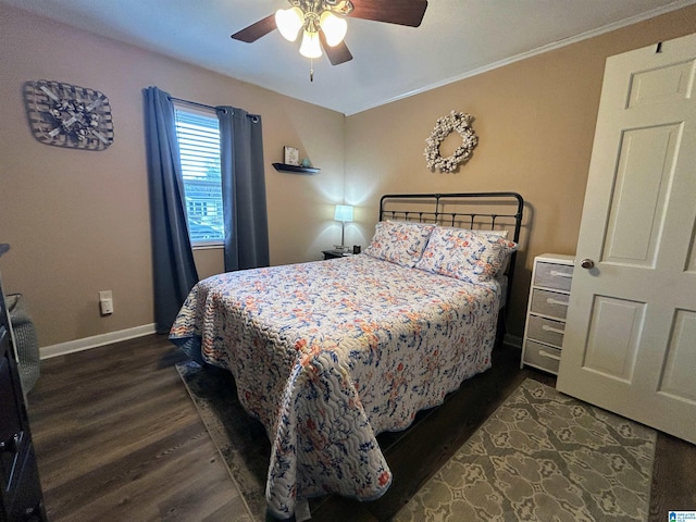 bedroom with dark hardwood / wood-style flooring, ceiling fan, and ornamental molding