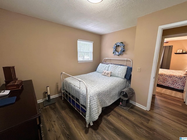 bedroom featuring dark hardwood / wood-style floors and a textured ceiling