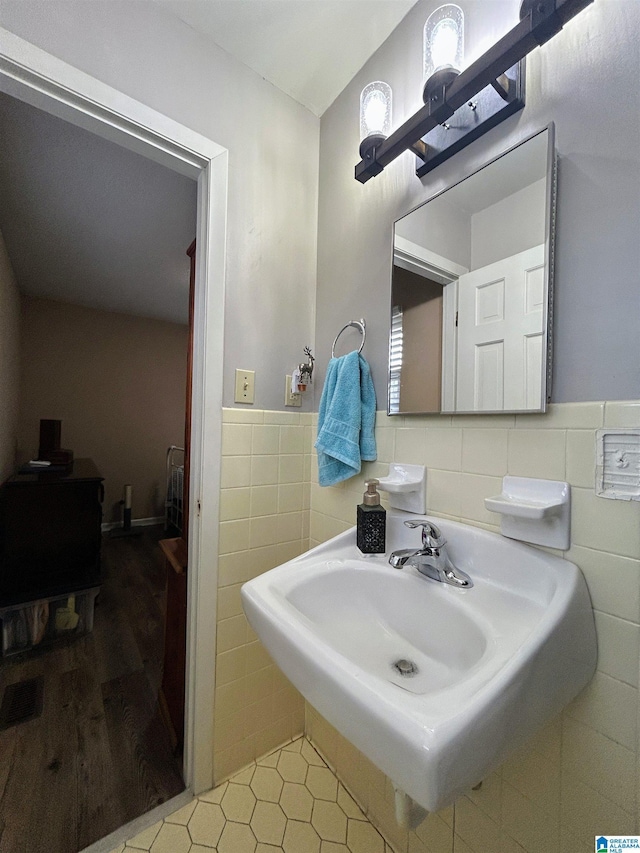 bathroom with sink, tile walls, and tile patterned flooring