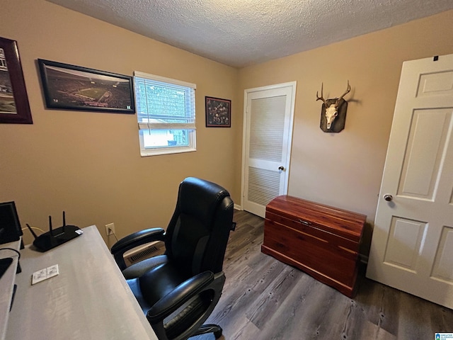 office featuring dark wood-type flooring and a textured ceiling