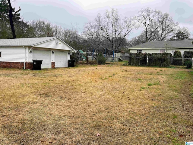 view of yard with an outdoor structure and a garage