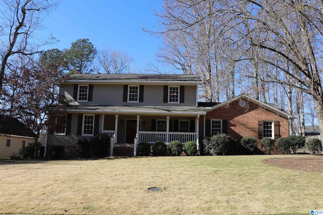 colonial inspired home featuring a front yard and a porch