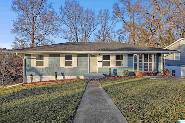 ranch-style home with a front lawn