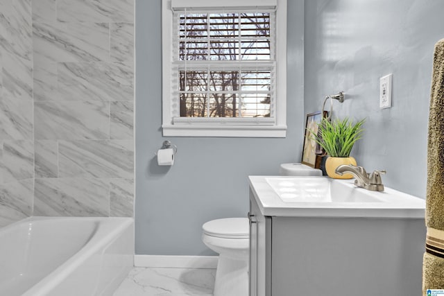 bathroom featuring vanity, toilet, and a tub to relax in