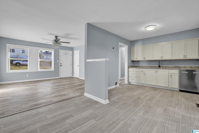 kitchen featuring ceiling fan, sink, stainless steel dishwasher, and light hardwood / wood-style flooring