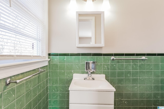 bathroom featuring vanity and tile walls