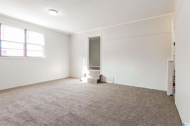 unfurnished room with carpet floors and ornamental molding