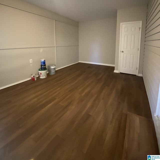 unfurnished room featuring dark hardwood / wood-style flooring