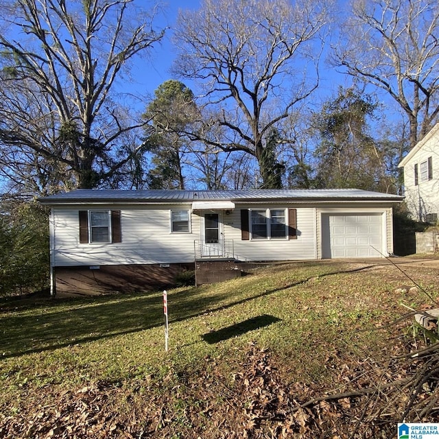 view of front of property with a garage and a front lawn