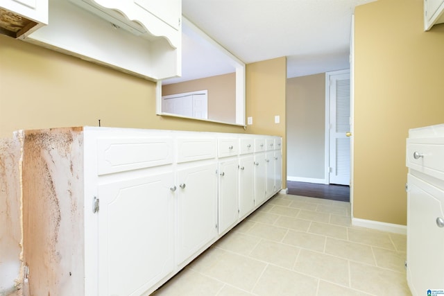 kitchen with white cabinetry and light tile patterned floors