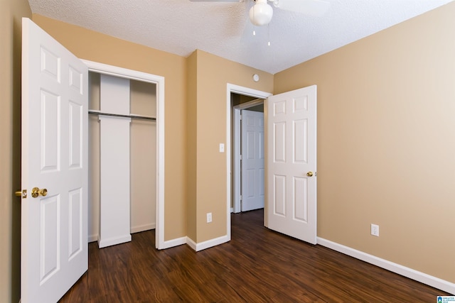 unfurnished bedroom with a textured ceiling, ceiling fan, a closet, and dark hardwood / wood-style floors