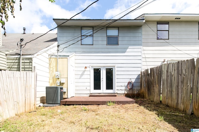 rear view of property featuring french doors, a deck, and central AC unit