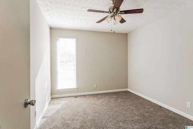 carpeted empty room with a textured ceiling and ceiling fan