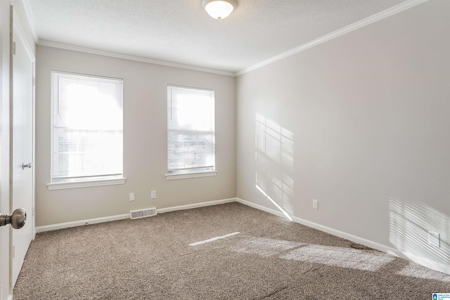 carpeted spare room featuring a textured ceiling and ornamental molding