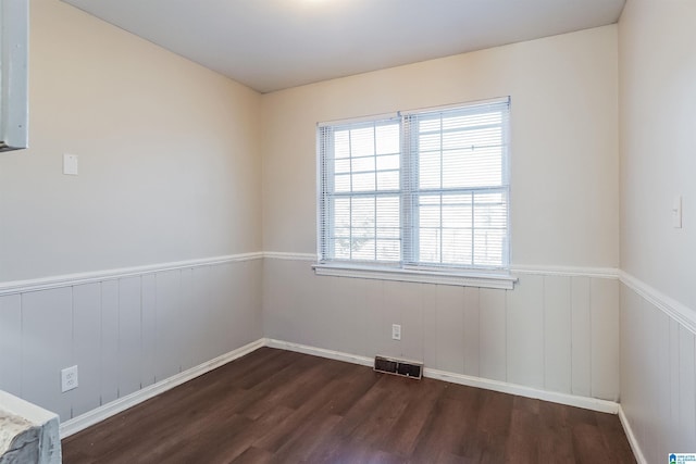 spare room with dark hardwood / wood-style flooring