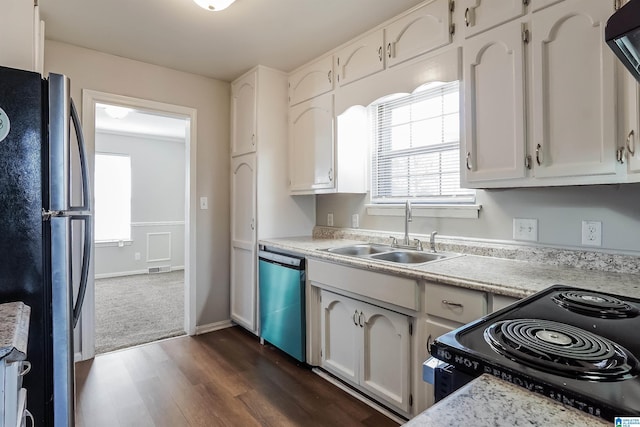 kitchen with dark hardwood / wood-style flooring, sink, white cabinets, and black appliances