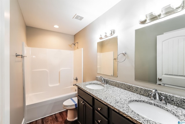 full bathroom with vanity, hardwood / wood-style flooring, toilet, and shower / washtub combination