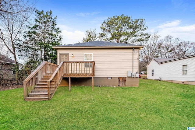 rear view of property featuring a yard and a wooden deck