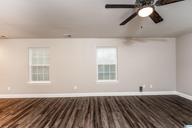 empty room featuring ceiling fan and dark wood-type flooring