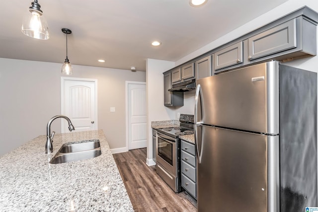 kitchen with light stone countertops, appliances with stainless steel finishes, sink, gray cabinets, and hanging light fixtures