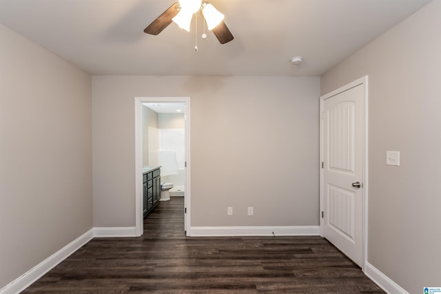 unfurnished room featuring ceiling fan and dark hardwood / wood-style floors