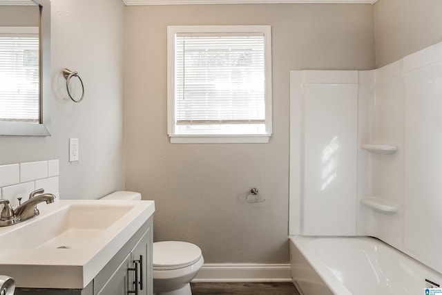 full bathroom with shower / bathing tub combination, vanity, toilet, and a wealth of natural light