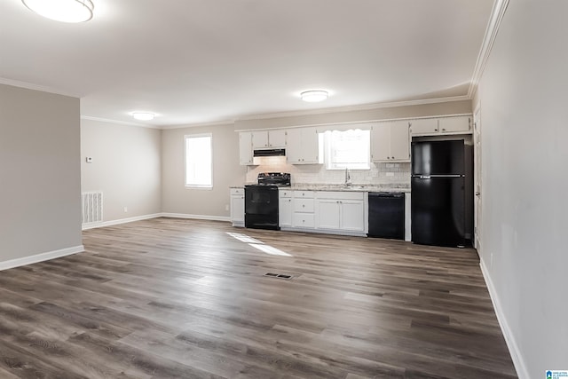 kitchen with tasteful backsplash, white cabinetry, ornamental molding, and black appliances