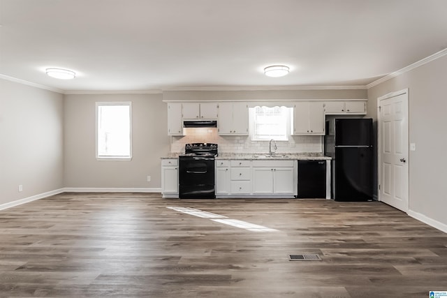 kitchen featuring a healthy amount of sunlight, white cabinets, and black appliances