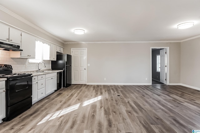 kitchen featuring white cabinetry, sink, tasteful backsplash, light hardwood / wood-style floors, and black appliances