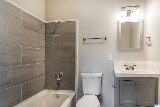 full bathroom featuring vanity, toilet, and tiled shower / bath