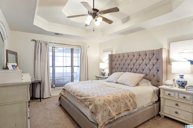 carpeted bedroom featuring ceiling fan, a raised ceiling, and ornamental molding