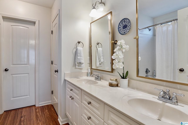 bathroom featuring wood-type flooring, vanity, and a shower with curtain