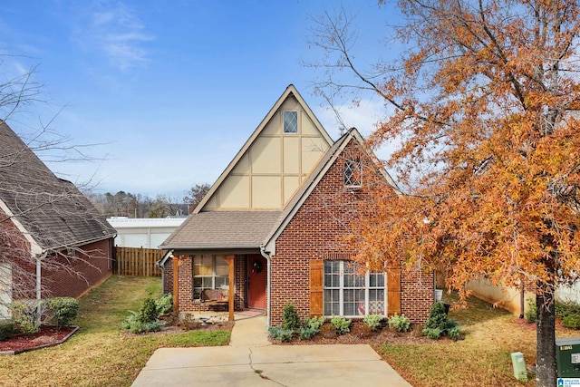 tudor-style house with a front lawn