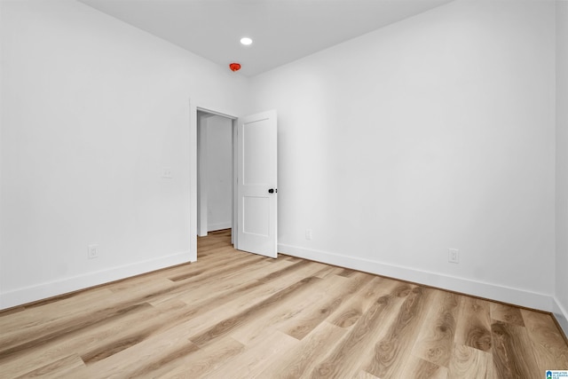 empty room with light hardwood / wood-style flooring