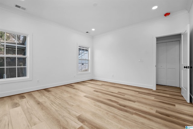 unfurnished bedroom with light hardwood / wood-style floors and crown molding