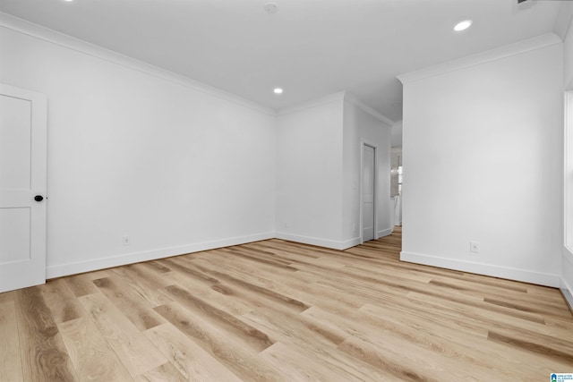 spare room with crown molding and light hardwood / wood-style flooring