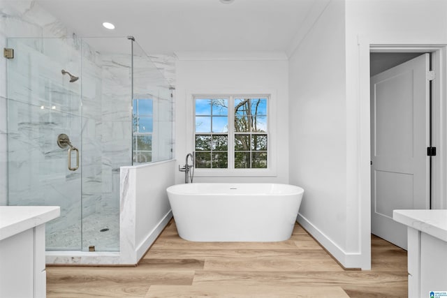 bathroom with vanity, hardwood / wood-style flooring, independent shower and bath, and crown molding