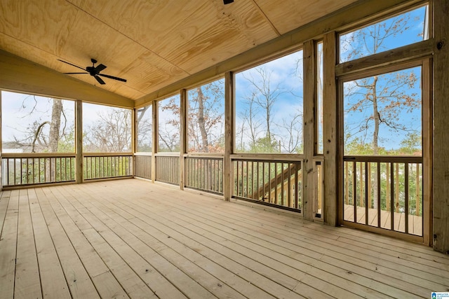 unfurnished sunroom featuring ceiling fan, wood ceiling, and vaulted ceiling