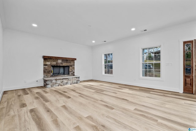 unfurnished living room featuring crown molding, a fireplace, and light hardwood / wood-style floors