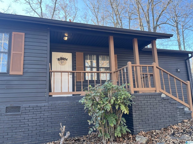 view of exterior entry featuring a porch