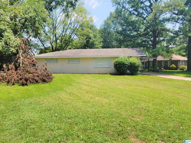 view of side of home with a lawn