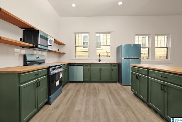 kitchen with stainless steel dishwasher, black range with gas cooktop, fridge, and wooden counters