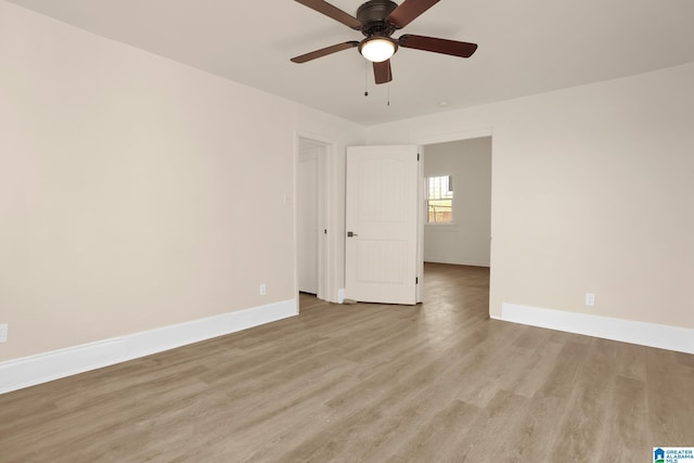 spare room with light wood-type flooring and ceiling fan