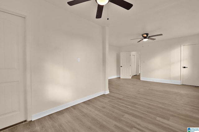 empty room with light wood-type flooring and ceiling fan