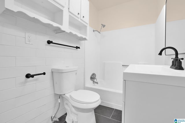 full bathroom with vanity, bathtub / shower combination, tile patterned flooring, toilet, and tile walls