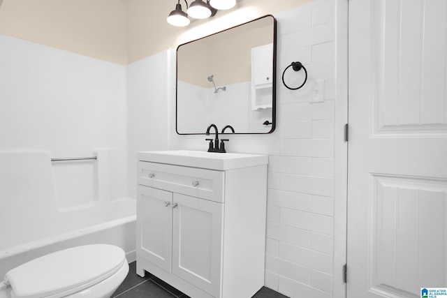 full bathroom featuring tile patterned floors, vanity, tub / shower combination, and toilet