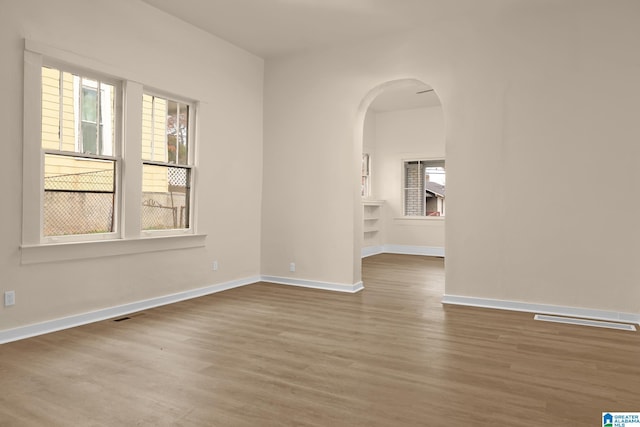 unfurnished room featuring hardwood / wood-style flooring