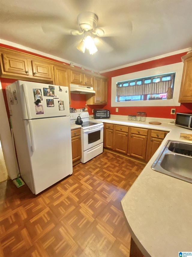 kitchen with ceiling fan, sink, dark parquet floors, crown molding, and white appliances