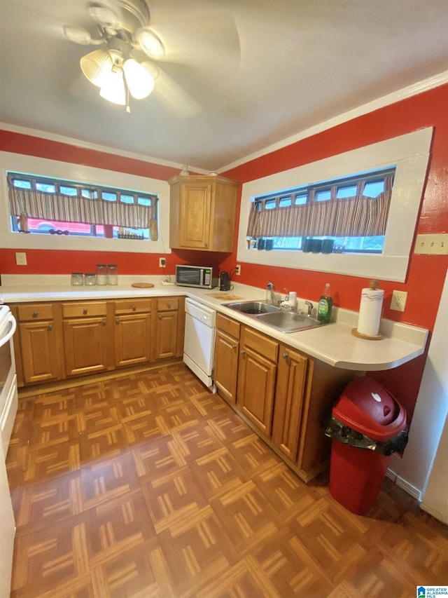 kitchen with white dishwasher, ceiling fan, dark parquet flooring, and sink